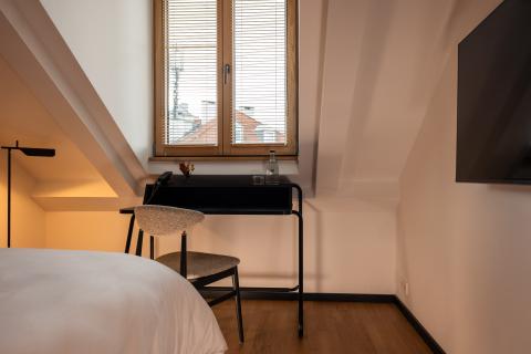 Attic room with desk right by the window